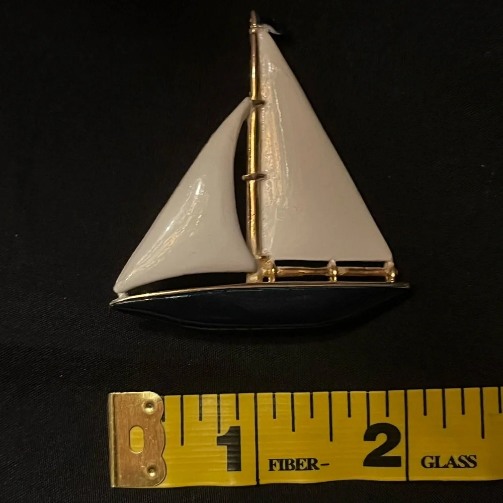 Gold tone sailboat brooch with white and blue enamel